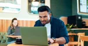 Cafe, thinking and man with laptop, typing and connection with inspiration, copywriting and plannin